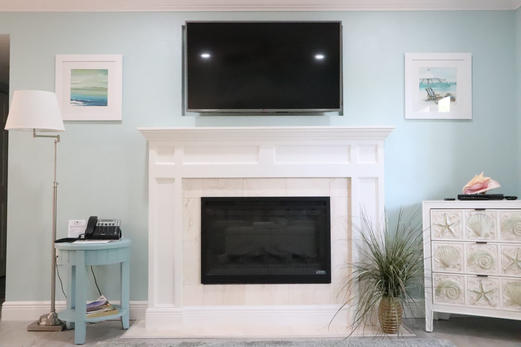 Finished living room with fireplace and mounted TV