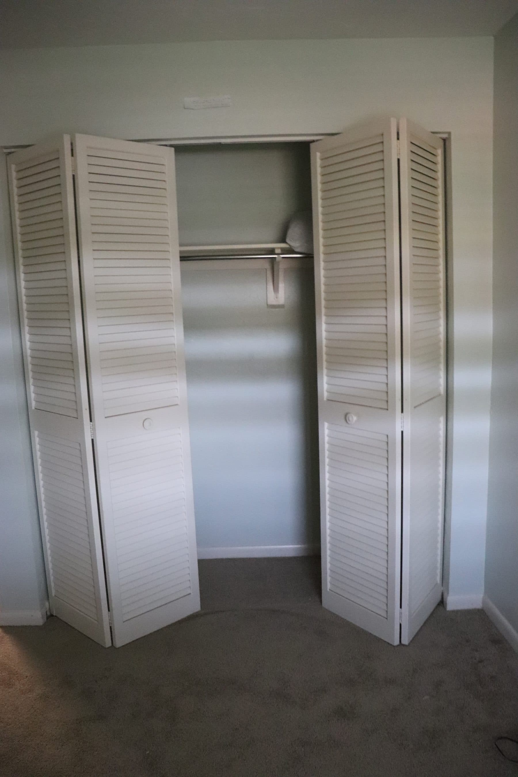 Empty closet with louvered doors