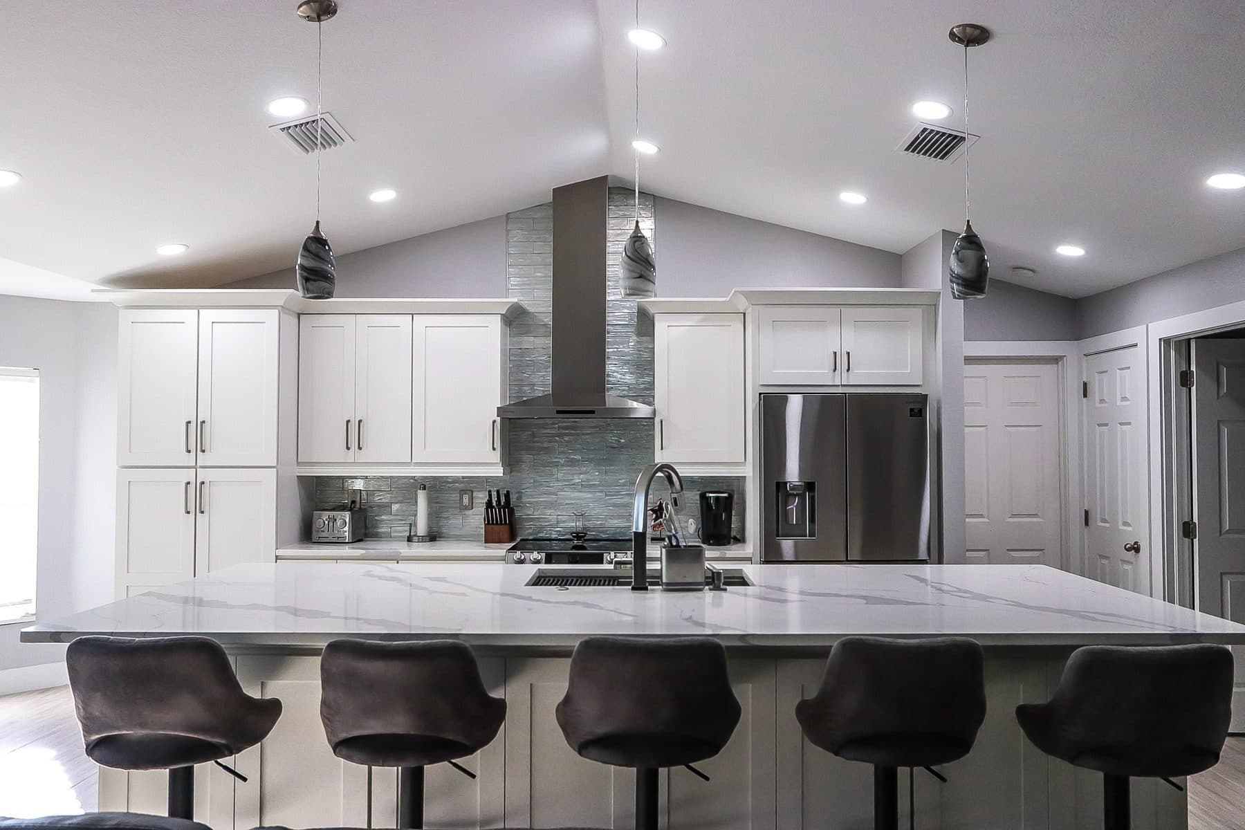 Contemporary white and black kitchen with vaulted ceiling