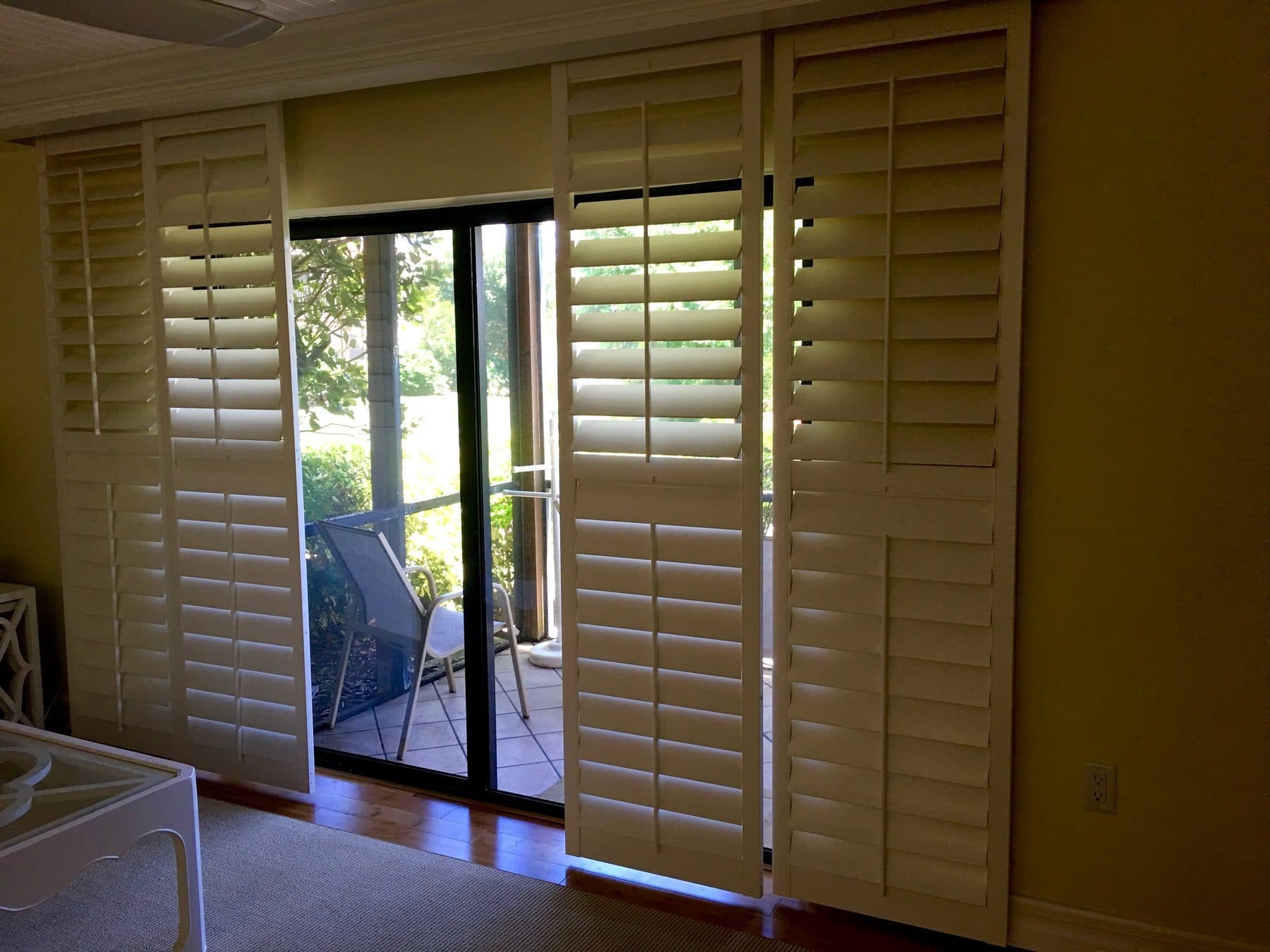Sliding glass door with plantation shutters open