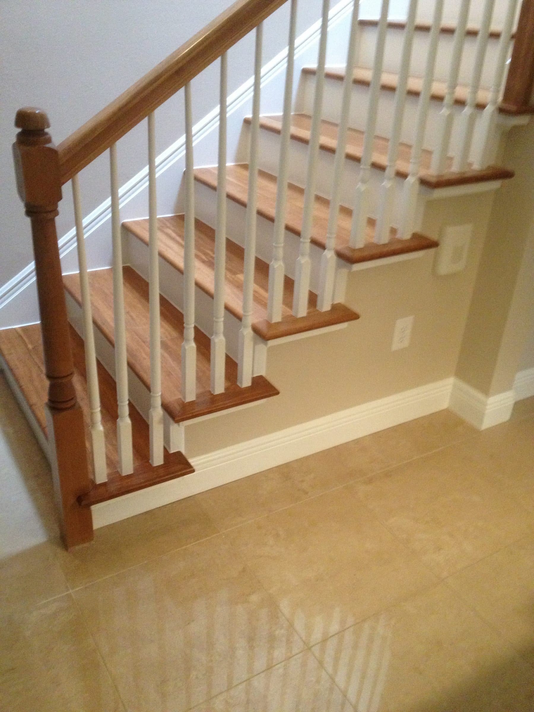 Traditional staircase with white spindle railing