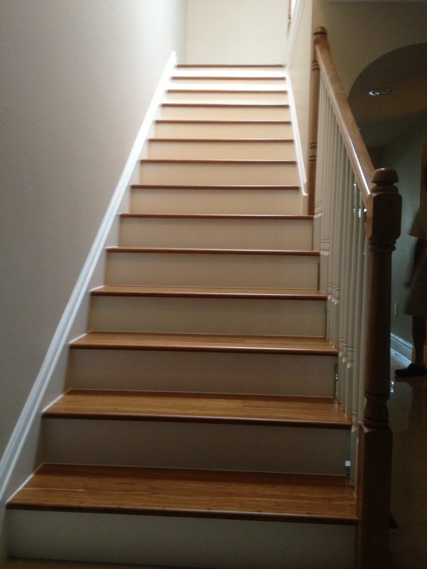 Staircase with dark wrought iron railing